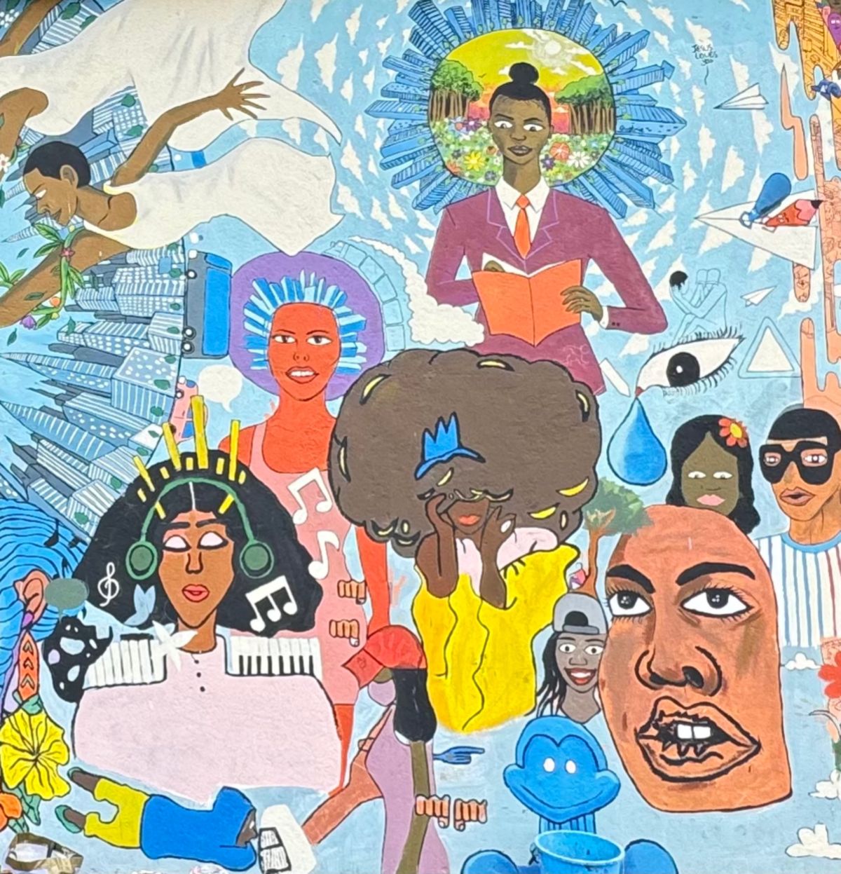 Painted mural of a crowd of stylised faces and figures, including one reading a book under a halo, with water drops, an eye and city towers.